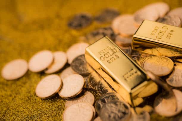 Gold bars and coins representing digital gold investment and wealth preservation.